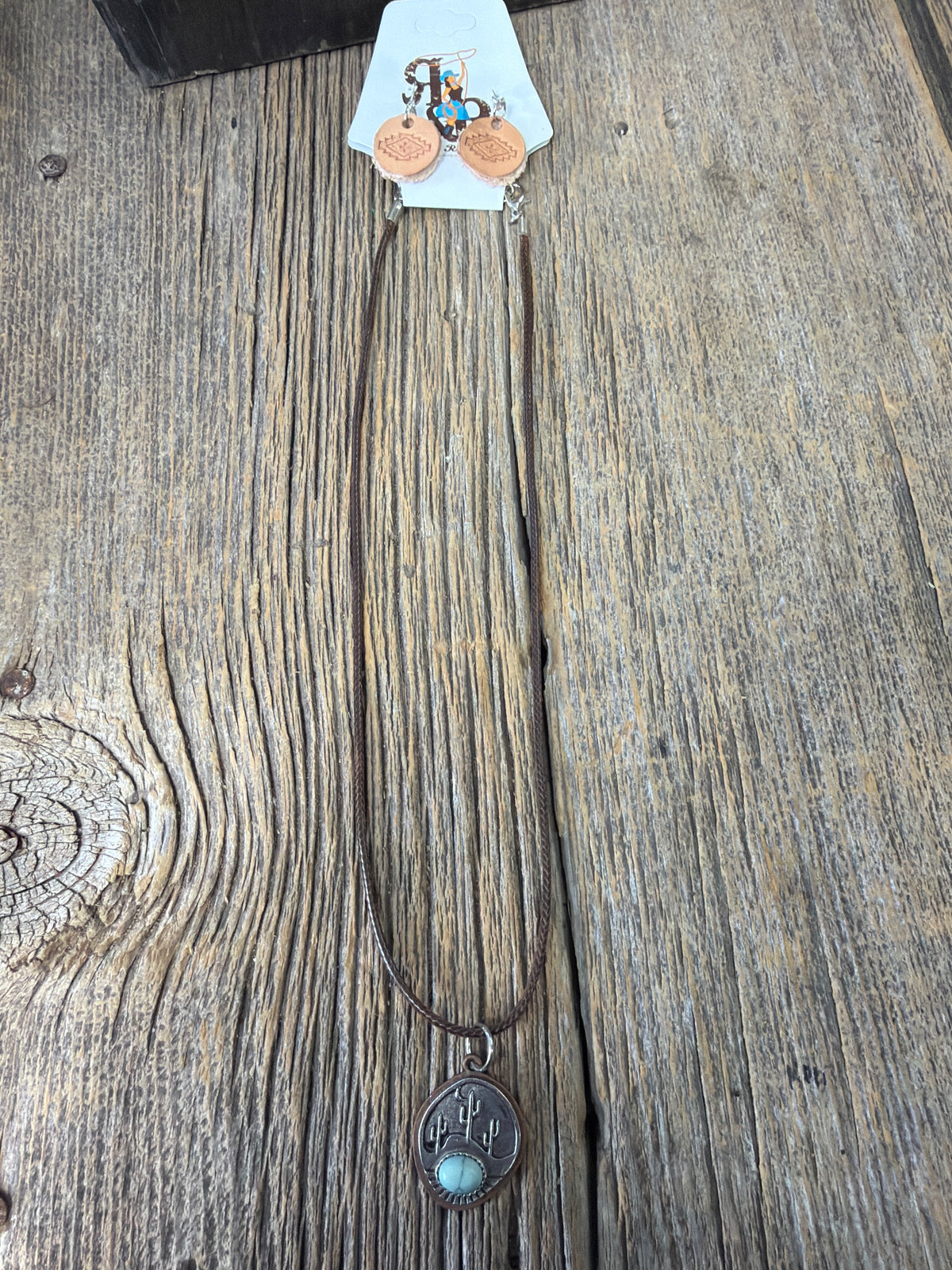 Handmade necklace with a silver cactus with turquoise pendant and handmade leather earrings ￼